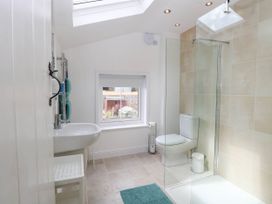 A bathroom with a shower and sink at 19 Covert Road in Reydon