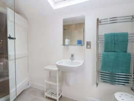 A bathroom with a sink and towels on a rail at 19 Covert Road in Reydon