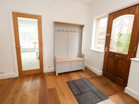 A hallway with a coat rack and entrance door at 29 Bincleaves Road in Weymouth