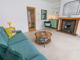 A living room with a sofa and table at 29 Bincleaves Road in Weymouth