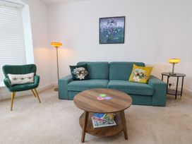 A living room with a sofa and table at 29 Bincleaves Road, Weymouth
