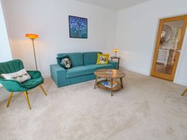 A living room with a sofa and armchair at 29 Bincleaves Road in Weymouth