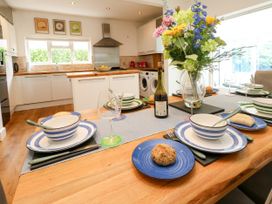 A kitchen with a dining table set for a meal at 29 Bincleaves Road Weymouth