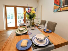 A dining room with a table set for a meal at 29 Bincleaves Road Weymouth