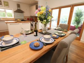 A dining room with a table set for dinner at 29 Bincleaves Road in Weymouth