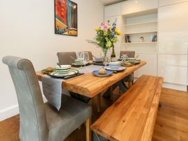 A dining room featuring a wooden table with dishes and chairs at 29 Bincleaves Road Weymouth