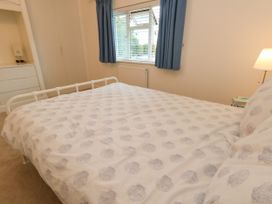 A bedroom with a bed and window at 29 Bincleaves Road Weymouth