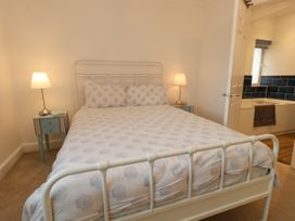 A bedroom with a bed and bedside table at 29 Bincleaves Road, Weymouth