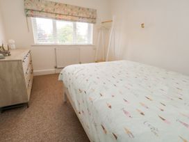 A bedroom with a bed and dresser at 29 Bincleaves Road, Weymouth