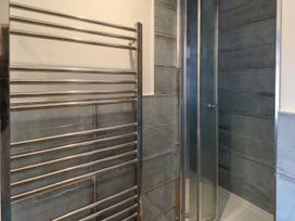 A bathroom with a shower and towel radiator at 29 Bincleaves Road Weymouth
