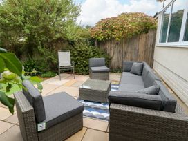 A garden with seating area and table at 29 Bincleaves Road Weymouth