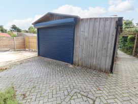 A garage with a blue door on an outdoor driveway at 29 Bincleaves Road Weymouth