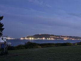 A view of an island with lights at Coast Path Cottage in Weymouth