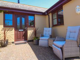 An outdoor area with chairs and a front door at Yonde View in Camborne