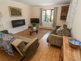 A living room with a television and a coffee table at Yonde View Camborne