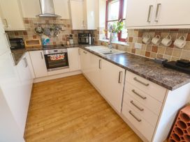 A kitchen with cabinets and appliances at Yonde View in Camborne
