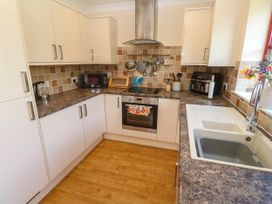 A kitchen with cabinets and appliances at Yonde View in Camborne