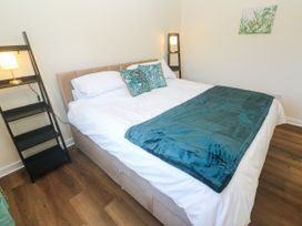 A bedroom with a bed and lamp at Yonde View in Camborne
