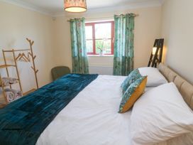 A bedroom with a bed and curtains at Yonde View Camborne
