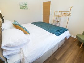 A bedroom with a bed and coat rack at Yonde View in Camborne