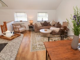 A living room with a sofa and coffee table at Gews Farm Lodge St Just