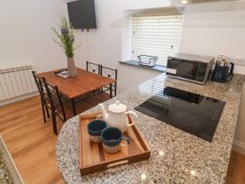A kitchen with a table and chairs at Gews Farm Lodge in St Just