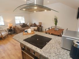 A kitchen with a countertop and seating area at Gews Farm Lodge St Just