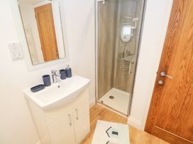 A bathroom with sink and shower at Gews Farm Lodge St Just