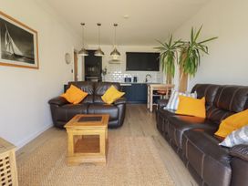 A living room with a sofa and coffee table at Rollies Retreat in Fowey