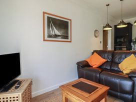 A living room with a sofa and coffee table at Rollies Retreat in Fowey