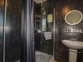 A bathroom with a shower and sink at Rollies Retreat in Fowey