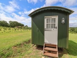 A shepherd's hut with steps and a door at Shepherds Hut at East Hill Pride Four Elms Hill Nr. Sidmouth