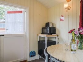 A kitchen with a table and chairs at Shepherds Hut at East Hill Pride Four Elms Hill Nr. Sidmouth