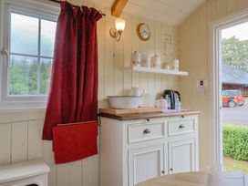 A kitchen space with a cabinet and kettle at Shepherds Hut at East Hill Pride in Four Elms Hill Nr. Sidmouth