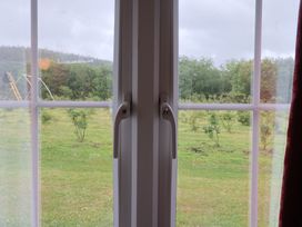 A window with a handle and grass outside at Shepherds Hut at East Hill Pride Four Elms Hill Nr. Sidmouth