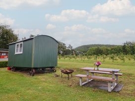 A shepherd's hut with a picnic table and fire pit at Shepherds Hut at East Hill Pride Four Elms Hill Nr. Sidmouth