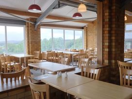 A dining area with tables and chairs at Shepherds Hut at East Hill Pride Four Elms Hill Nr. Sidmouth