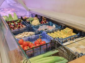 A grocery display with various vegetables and packaged food items at a supermarket