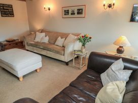 A living room with a sofa and coffee table at 2 The Gardens Lechlade