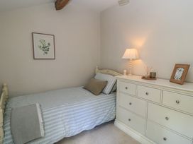 A bedroom with a bed and chest of drawers at 2 The Gardens Lechlade