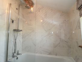 A bathroom with a shower and bathtub at 2 The Gardens in Lechlade