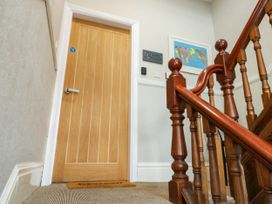 A staircase leading to a door at Flat 3 in Llandudno