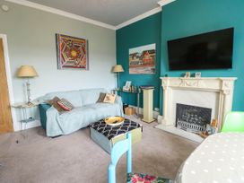 A living room with a sofa and fireplace at Flat 3 in Llandudno