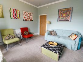 A living room with a sofa and armchairs at Flat 3 in Llandudno