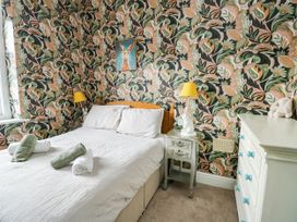 A bedroom with a bed and lamp at Flat 3 Llandudno