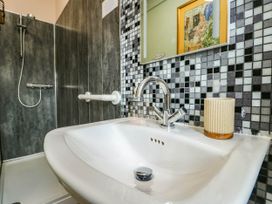 A bathroom with a sink and shower at Flat 3 in Llandudno