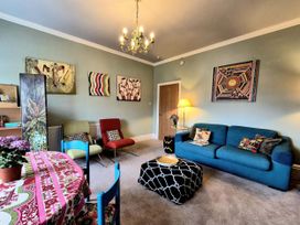 A living room with a sofa and table at Flat 3 in Llandudno