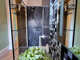 A bathroom with a shower and toilet at Flat 3 in Llandudno