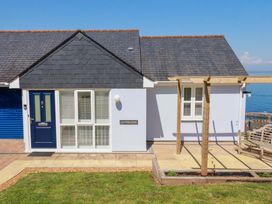 A house with a blue door and sign at Trewollock in Mevagissey