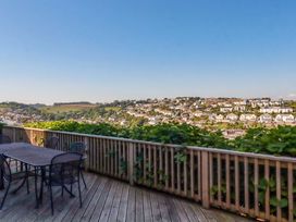 An outdoor area with a table and chairs at Trewollock in Mevagissey